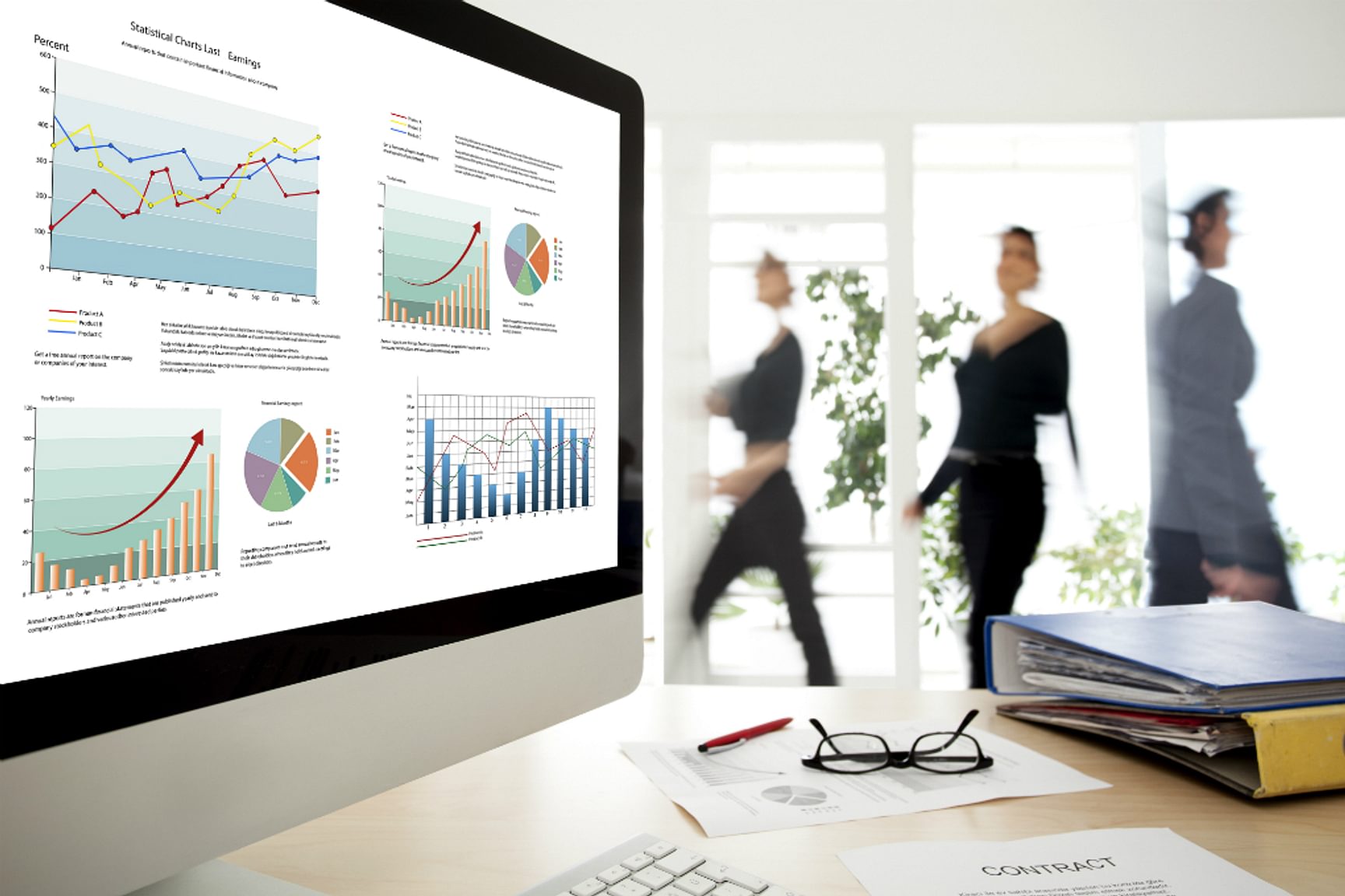 Een afbeelding van monitor met data-analyses en grafieken, met VGD-medewerkers op de achtergrond.